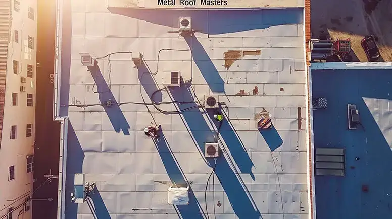 professional roofers showing works on a commercial building